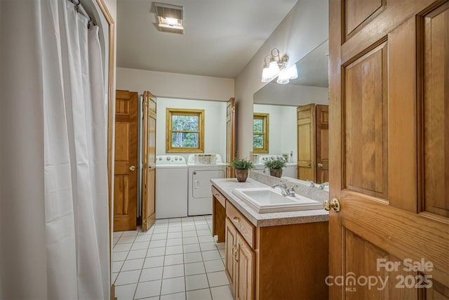 full bathroom featuring washer and clothes dryer, tile patterned floors, and vanity