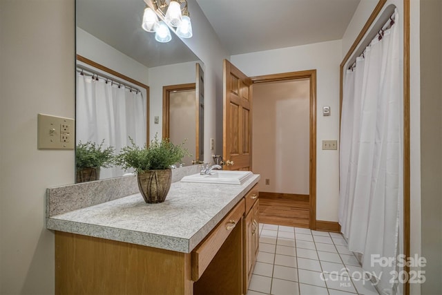 full bathroom featuring baseboards, tile patterned floors, and vanity