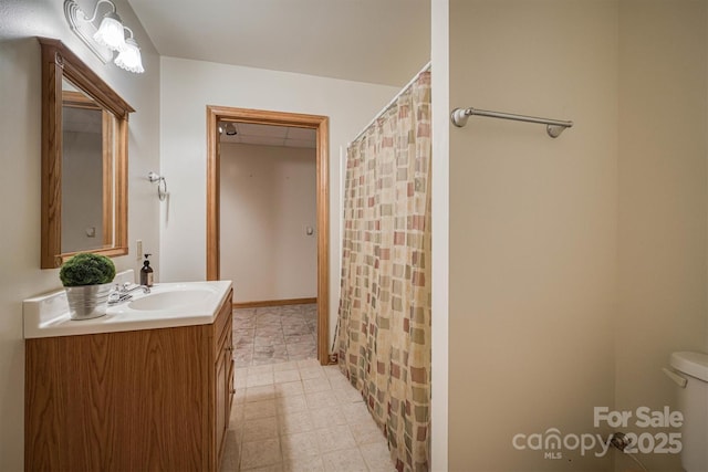 bathroom featuring vanity and toilet