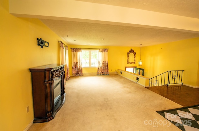interior space with baseboards and carpet