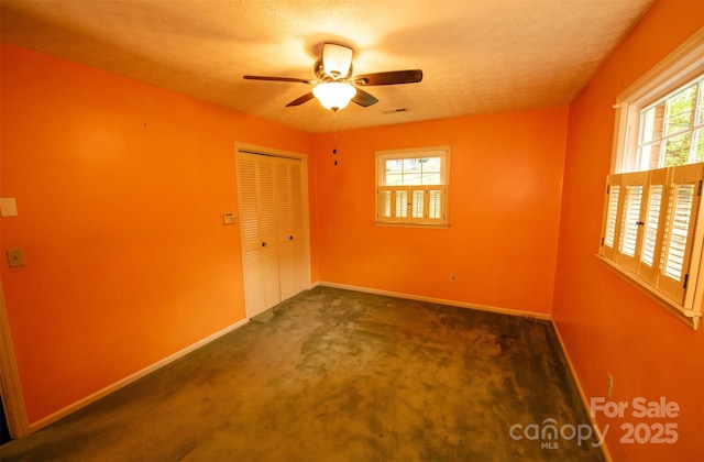 unfurnished room with baseboards, a ceiling fan, and carpet floors