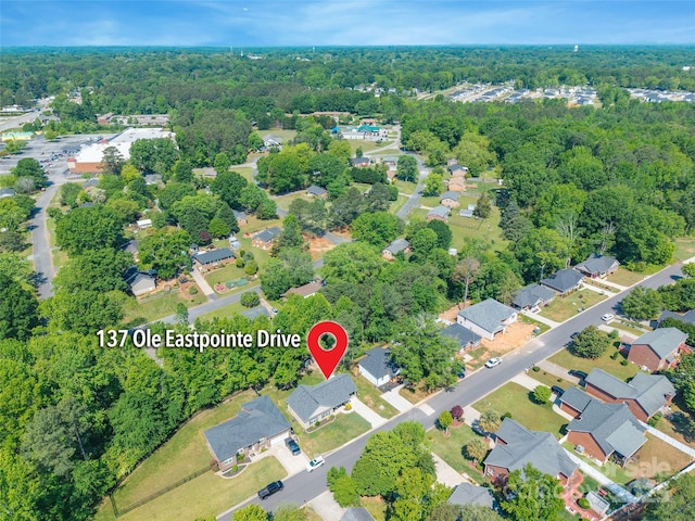 bird's eye view with a wooded view