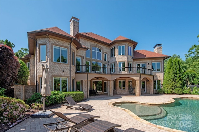 8904 Woodhall Lake Dr, Waxhaw, NC 28173 - rear view of house with a patio, a chimney, and a balcony