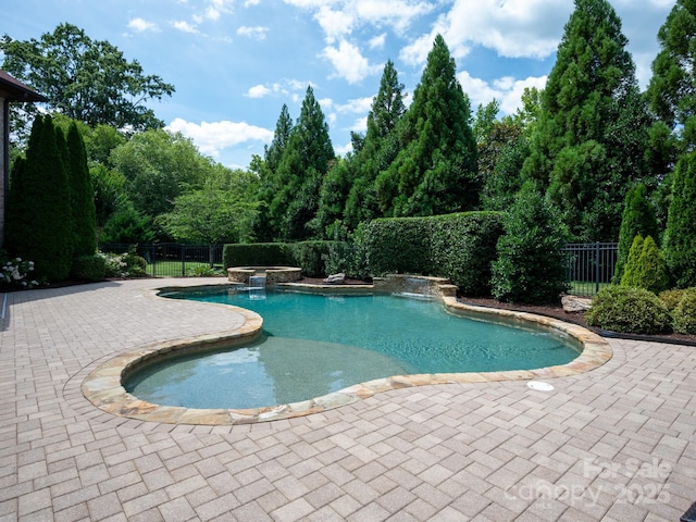 8904 Woodhall Lake Dr, Waxhaw, NC 28173 - view of pool featuring fence, a pool with connected hot tub, and a patio area