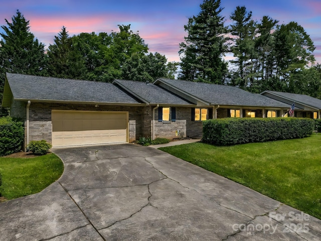 209 Daniel Dr, Hendersonville, NC 28739 - single story home featuring driveway, an attached garage, brick siding, and a front lawn