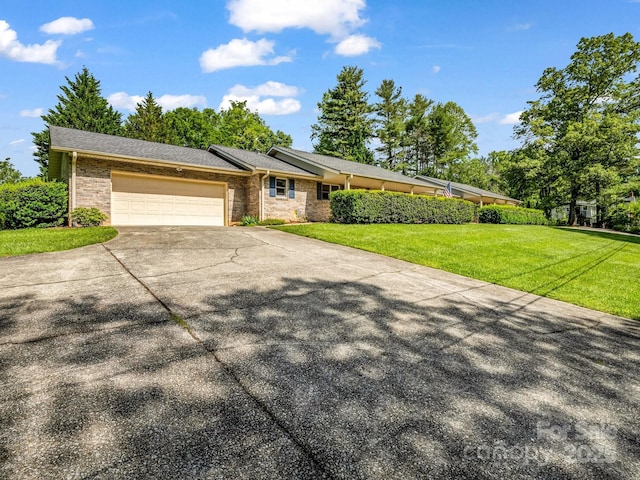 209 Daniel Dr, Hendersonville, NC 28739 - single story home with concrete driveway, an attached garage, brick siding, and a front lawn