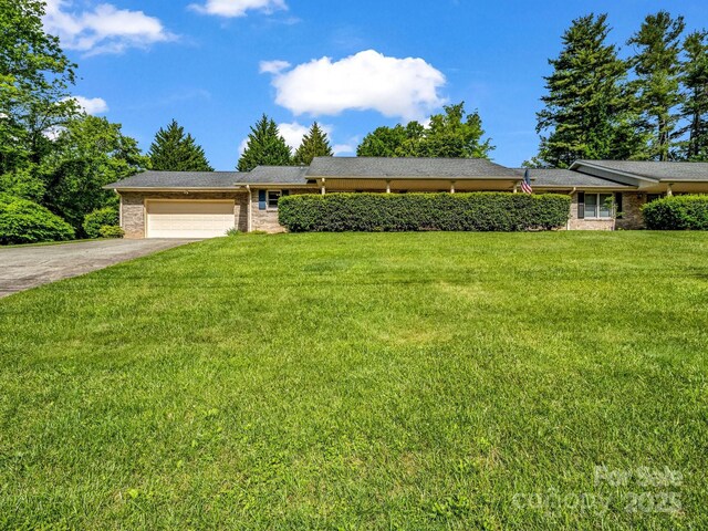 209 Daniel Dr, Hendersonville, NC 28739 - ranch-style house with an attached garage, concrete driveway, a front yard, and brick siding
