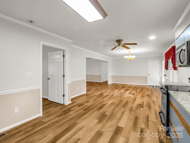 209 Daniel Dr, Hendersonville, NC 28739 - unfurnished living room with ornamental molding, light wood-style flooring, baseboards, ceiling fan, and a chandelier