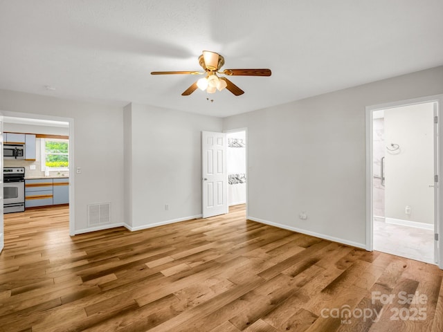 209 Daniel Dr, Hendersonville, NC 28739 - empty room with a ceiling fan, light wood-style floors, and baseboards