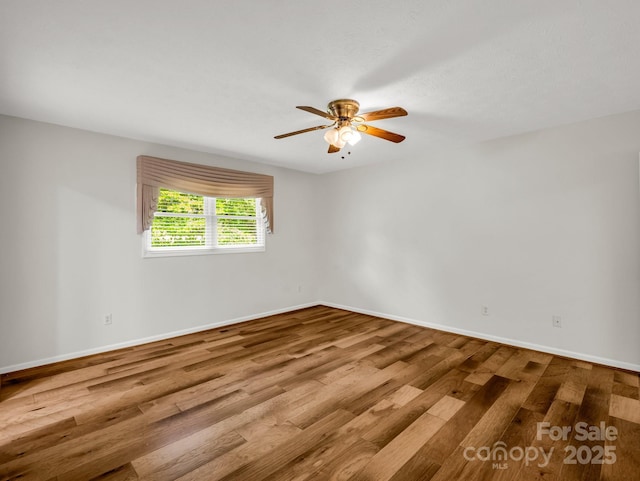 209 Daniel Dr, Hendersonville, NC 28739 - spare room with wood finished floors, ceiling fan, and baseboards