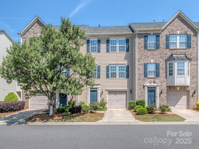 2125 Belle Vernon Ave, Charlotte, NC 28210 - multi unit property with concrete driveway, a garage, and brick siding