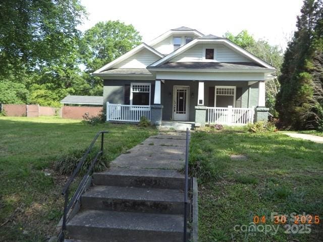 bungalow with a porch and a front yard