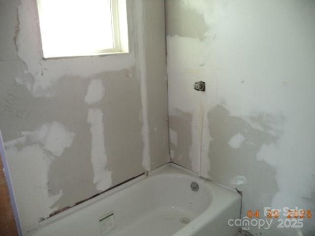 bathroom with a shower and a bath