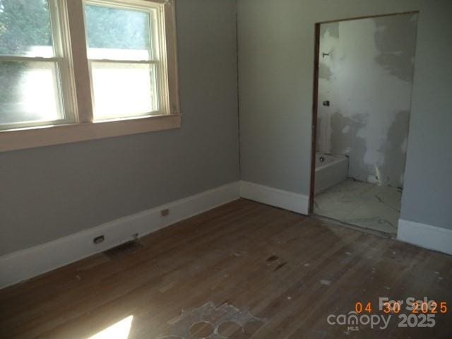 unfurnished bedroom featuring baseboards and wood finished floors
