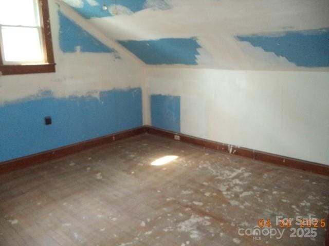 bonus room with baseboards and lofted ceiling