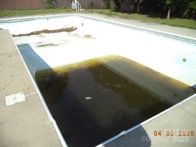 view of swimming pool with an empty pool