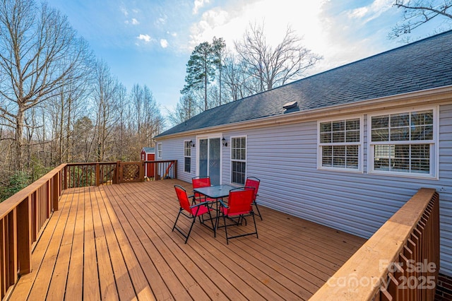 wooden terrace featuring outdoor dining area