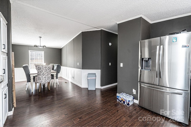 kitchen with stainless steel fridge with ice dispenser, wood finished floors, a decorative wall, ornamental molding, and a textured ceiling