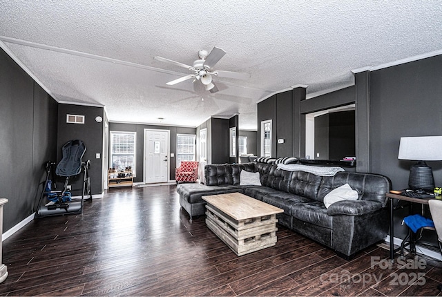 living area featuring wood finished floors, a ceiling fan, a textured ceiling, baseboards, and ornamental molding