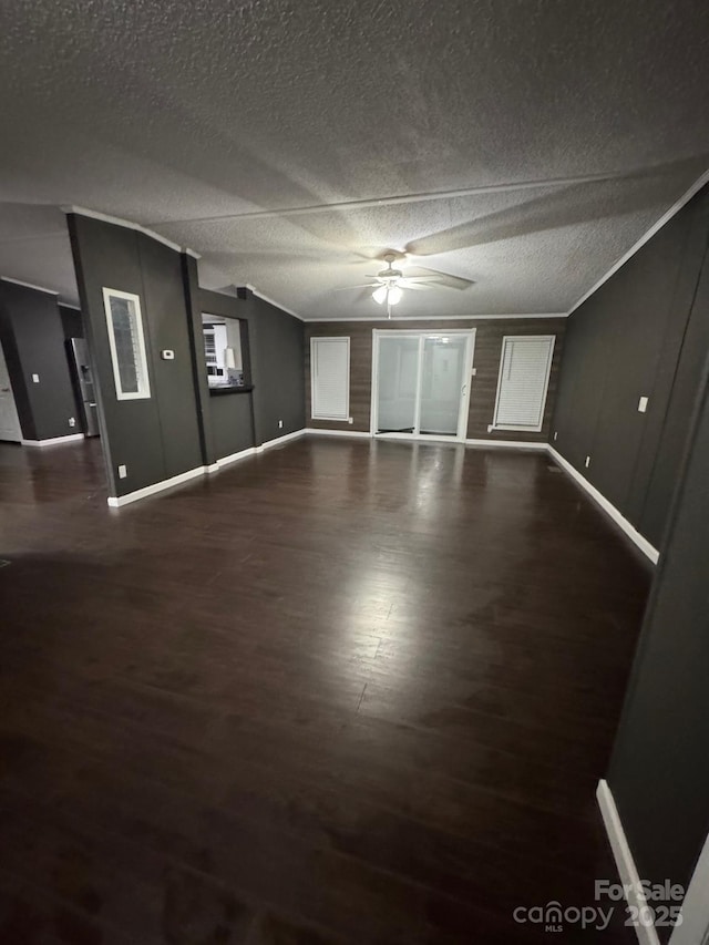 unfurnished living room with baseboards, ceiling fan, wood finished floors, and a textured ceiling