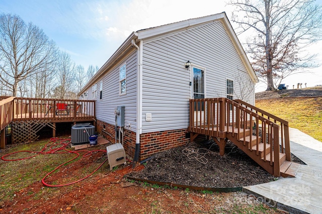 back of house with cooling unit, a wooden deck, and crawl space