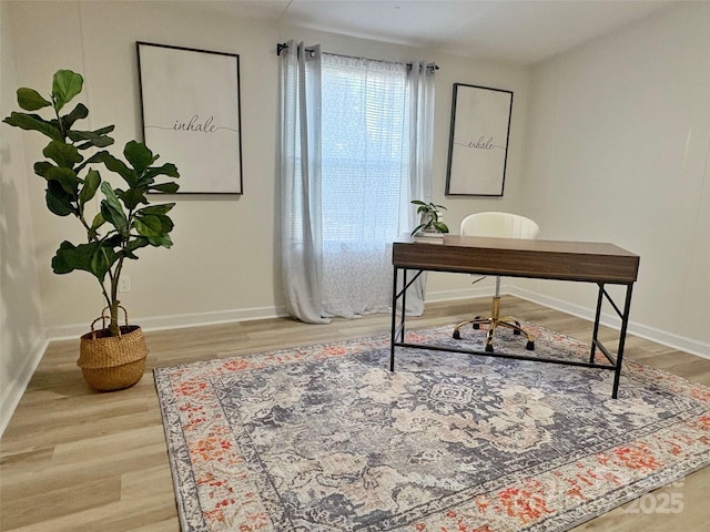 home office featuring baseboards and wood finished floors