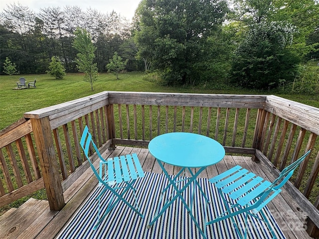 wooden deck featuring a yard