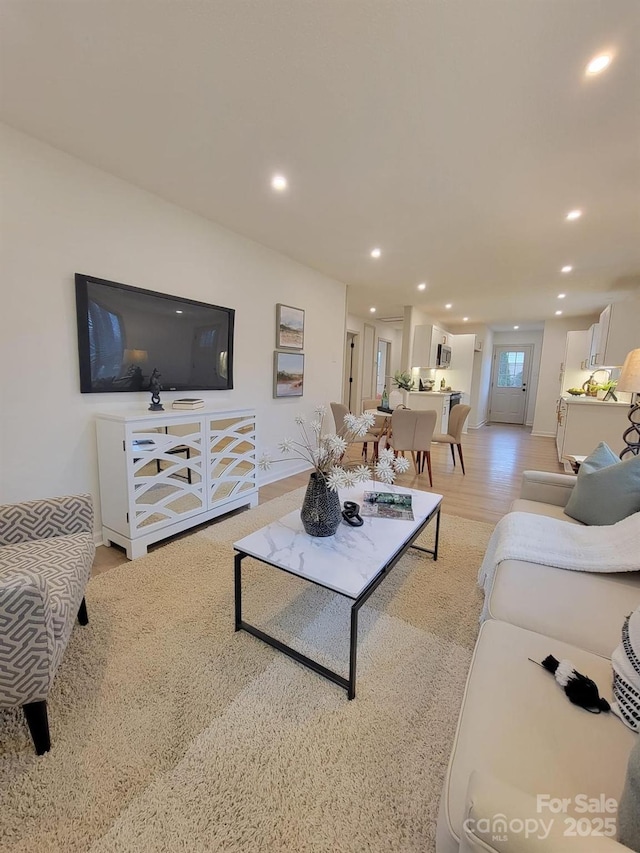 living room featuring recessed lighting and light wood finished floors