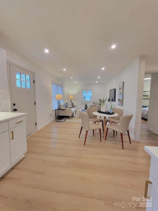 dining space featuring light wood-type flooring, recessed lighting, and a healthy amount of sunlight