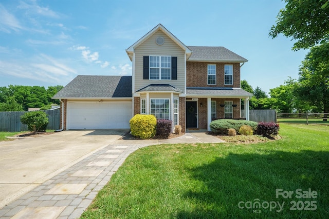 traditional-style house featuring a front lawn, fence, brick siding, an attached garage, and driveway