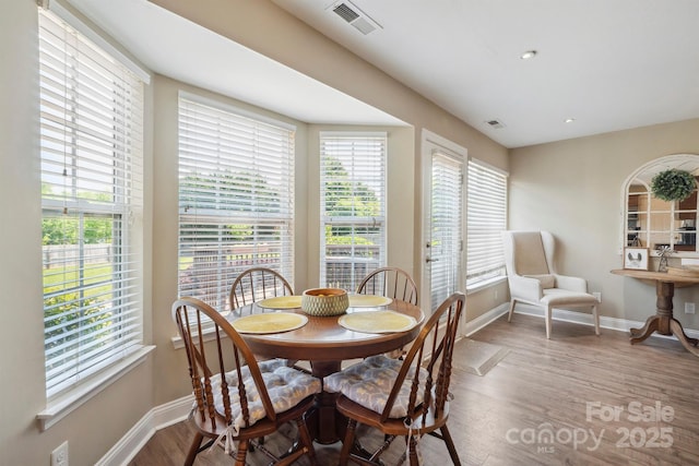 dining area with recessed lighting, baseboards, visible vents, and wood finished floors