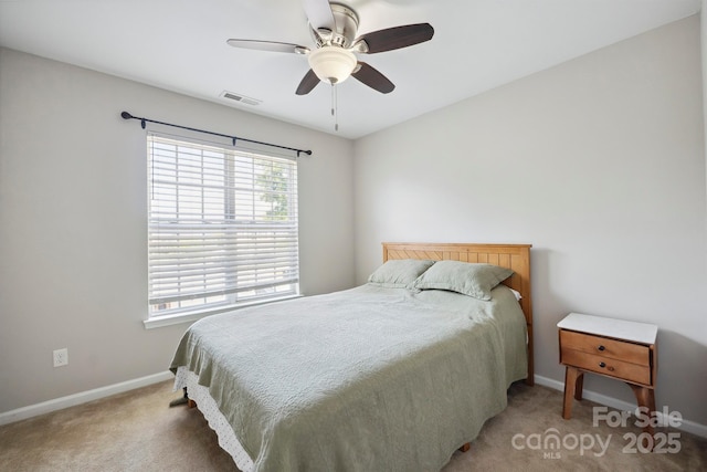 carpeted bedroom with baseboards, visible vents, and ceiling fan