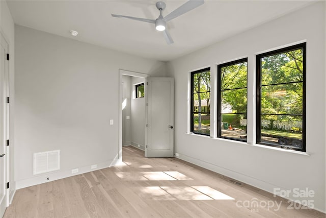 624 Heather Ln, Charlotte, NC 28209 - unfurnished bedroom featuring wood finished floors, baseboards, and a ceiling fan