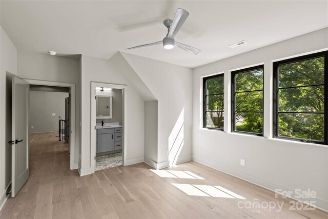 624 Heather Ln, Charlotte, NC 28209 - unfurnished bedroom with light wood-style flooring, baseboards, and a sink
