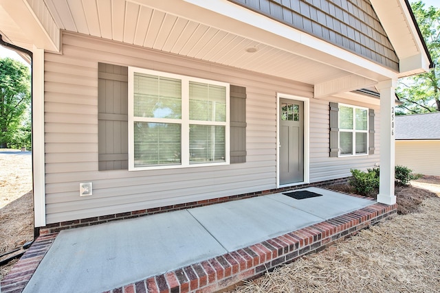 view of exterior entry featuring a porch