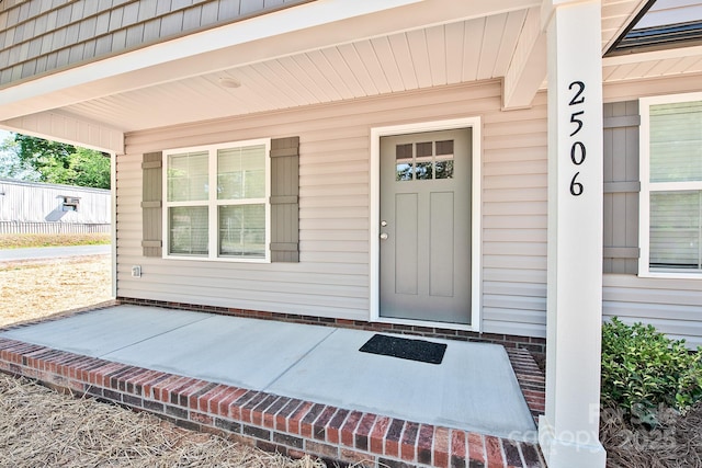 view of exterior entry featuring a porch