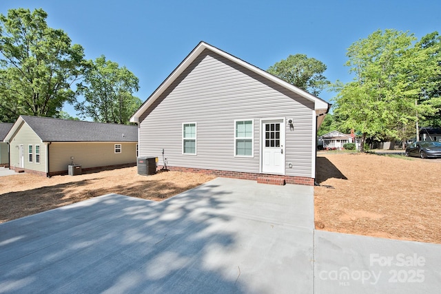 view of side of home with central AC