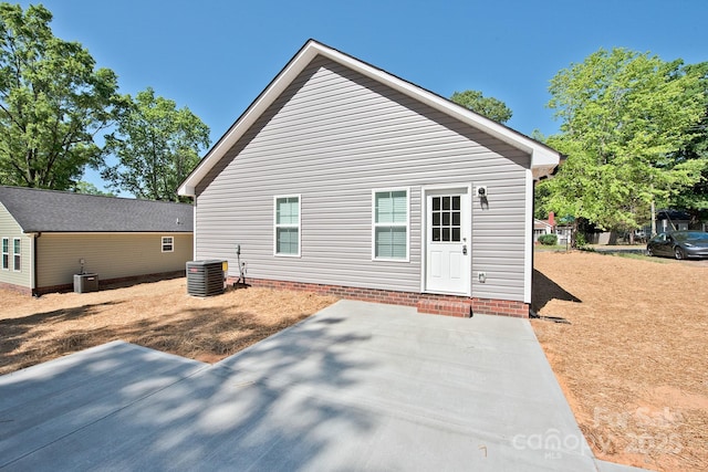 back of house with central air condition unit and a patio area