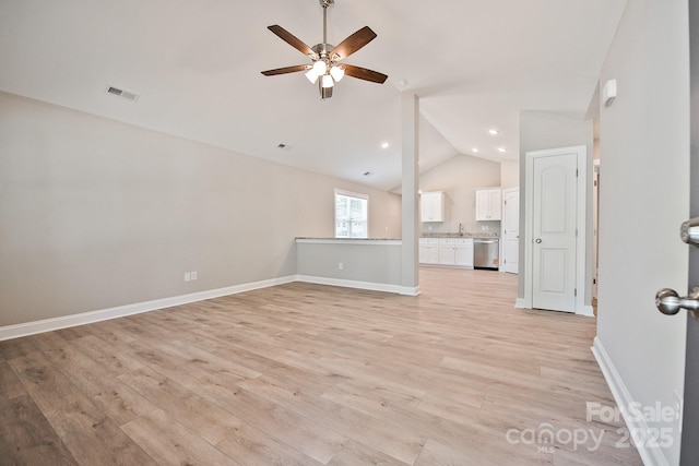unfurnished living room featuring visible vents, lofted ceiling, baseboards, light wood-type flooring, and a ceiling fan