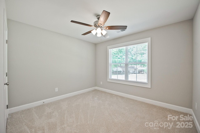 unfurnished room with baseboards, carpet flooring, and ceiling fan
