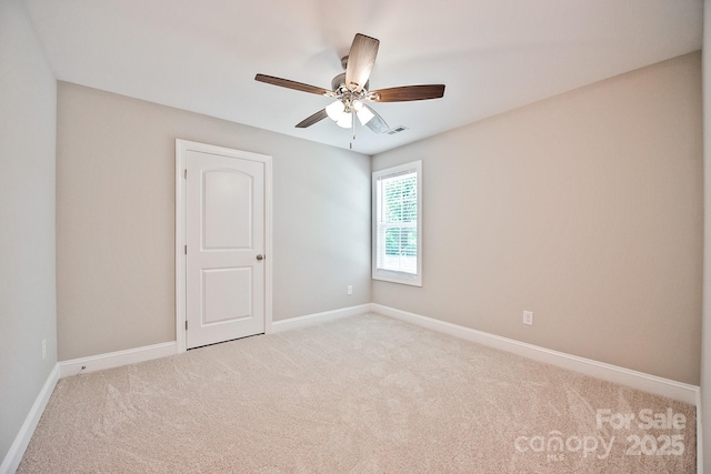 empty room featuring visible vents, a ceiling fan, carpet, and baseboards