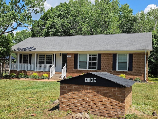 1109 Reid Harkey Rd, Matthews, NC 28105 - ranch-style house with brick siding, a front lawn, a porch, and a shingled roof