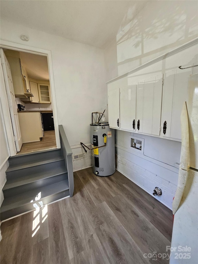 1109 Reid Harkey Rd, Matthews, NC 28105 - washroom featuring water heater, dark wood-style floors, cabinet space, and hookup for a washing machine