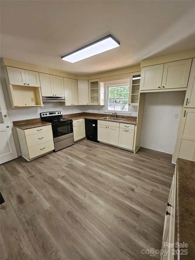1109 Reid Harkey Rd, Matthews, NC 28105 - kitchen featuring electric stove, under cabinet range hood, dark countertops, black dishwasher, and glass insert cabinets