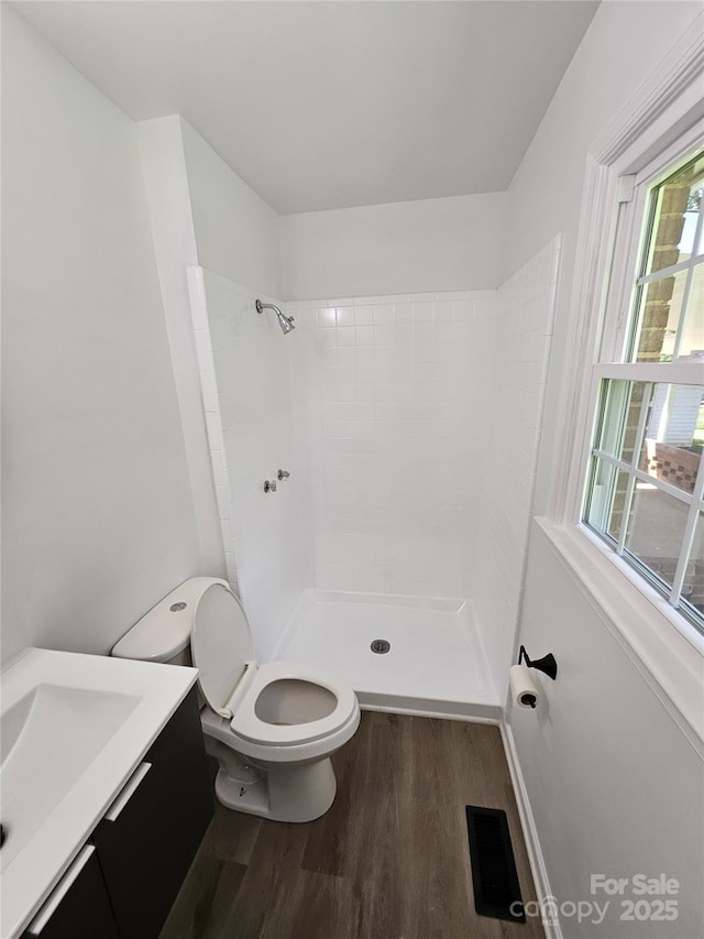 1109 Reid Harkey Rd, Matthews, NC 28105 - full bath with wood finished floors, toilet, vanity, and a tile shower