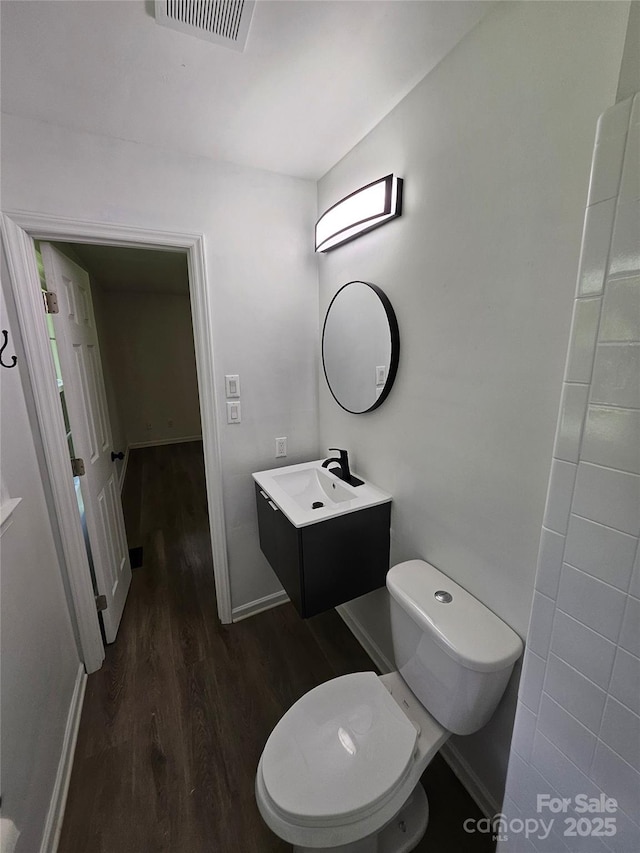 1109 Reid Harkey Rd, Matthews, NC 28105 - bathroom with wood finished floors, vanity, toilet, and baseboards
