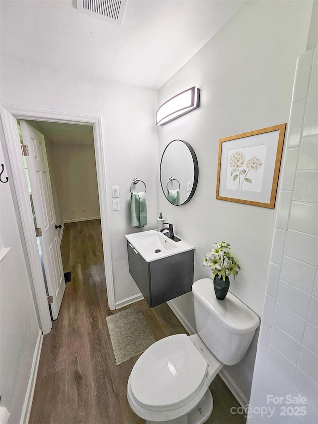1109 Reid Harkey Rd, Matthews, NC 28105 - bathroom with wood finished floors, vanity, toilet, and baseboards