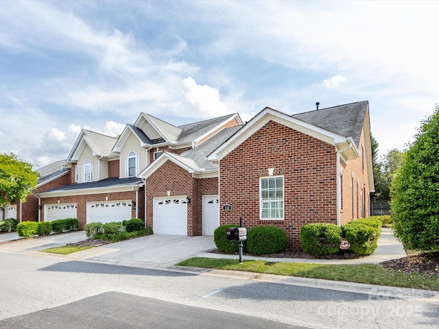 140 Villa Lake Dr, Fort Mill, SC 29708 - view of front of home featuring brick siding, driveway, a garage, and a shingled roof