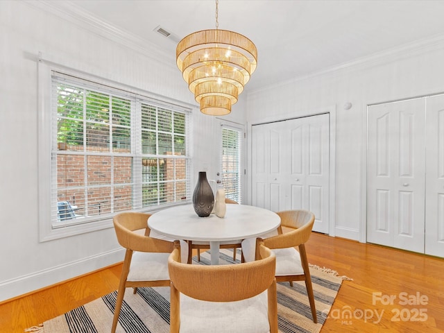 140 Villa Lake Dr, Fort Mill, SC 29708 - dining room featuring crown molding, a chandelier, baseboards, and light wood-style flooring