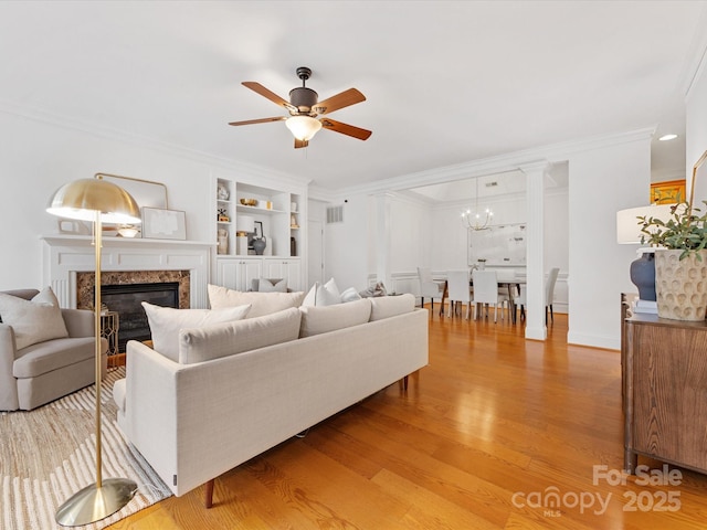 140 Villa Lake Dr, Fort Mill, SC 29708 - living room with ceiling fan, light wood finished floors, ornamental molding, a chandelier, and a premium fireplace